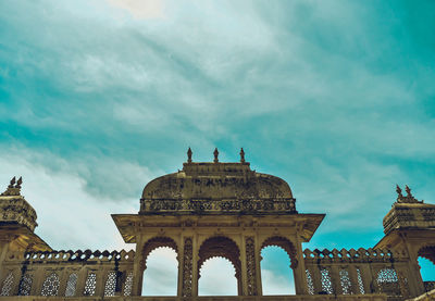 Low angle view of historical building against cloudy sky