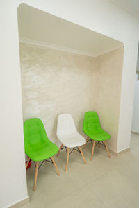 Empty chairs and table against wall at home