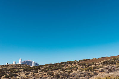 Low angle view of mountain against clear blue sky