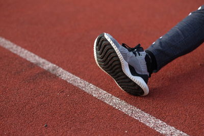 Low section of person on running track