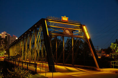 Low angle view of bridge against sky at night