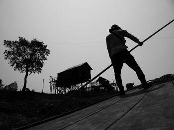 Full length of woman standing by railing