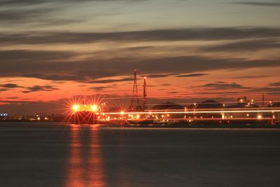 Scenic view of illuminated bridge against sky at sunset