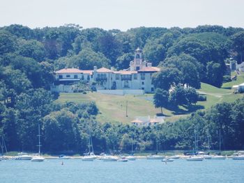 Scenic view of lake by trees and buildings