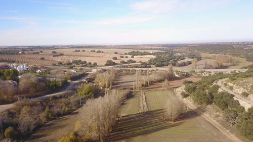 High angle view of road amidst trees against sky