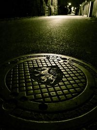 Close-up of manhole in park at night