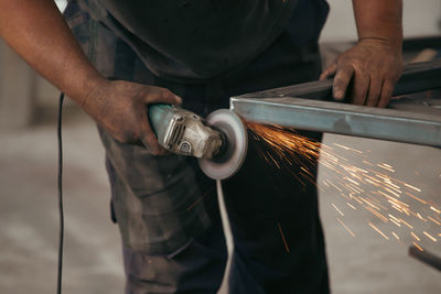 Midsection of man working in workshop