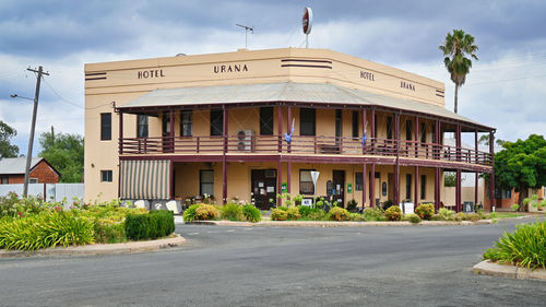 Building by road against sky