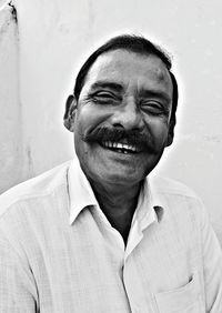 Portrait of happy man against wall