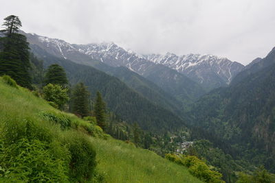 Scenic view of valley and mountains against sky