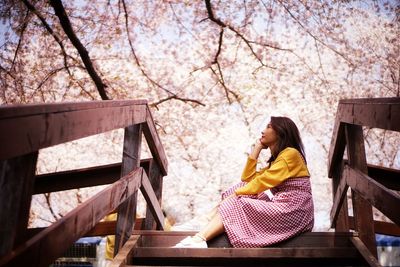 Low angle view of thoughtful woman sitting on steps