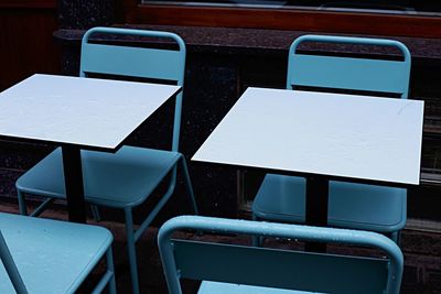 Close-up of chairs on table