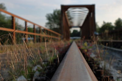 Close-up of railroad tracks against sky