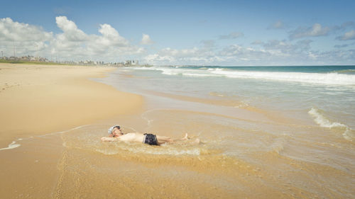 High angle view of man surfing on beach