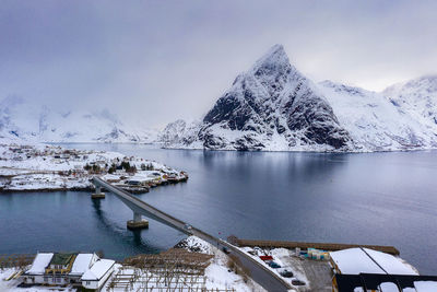 Scenic view of snowcapped mountains by lake against sky