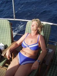 Young woman sitting on boat sailing in sea