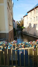 Group of people in canal by buildings in city