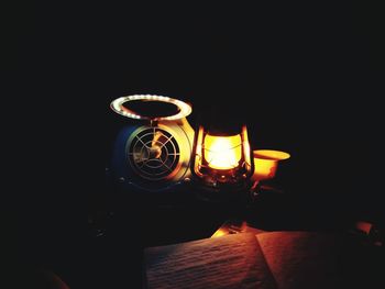 Close-up of illuminated lamp in darkroom