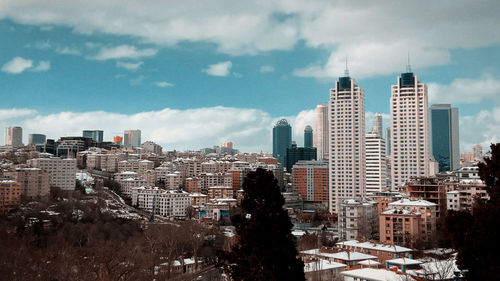 Buildings in city against sky