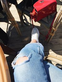 Low section of woman standing on chair