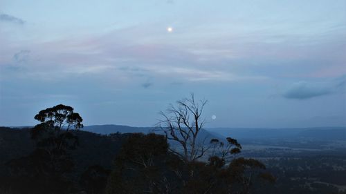 Scenic view of mountains against sky at dusk