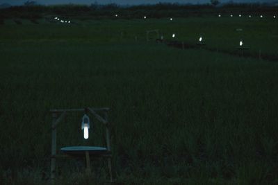 Built structure on field against sky at night