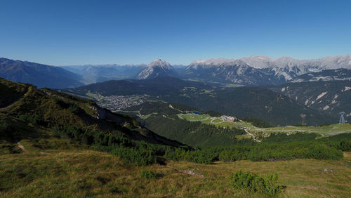 Scenic view of mountains against clear blue sky