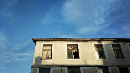 Street journals- low angle view of windows of building against sky