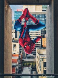 Low angle view of statue against buildings in city