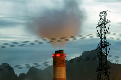 Low angle view of electricity pylon against sky