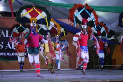 Group of people dancing at music concert