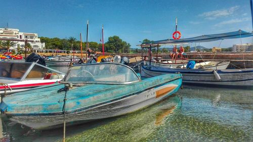 Boats moored on sea against sky