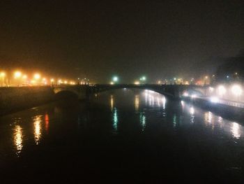 Illuminated bridge at night