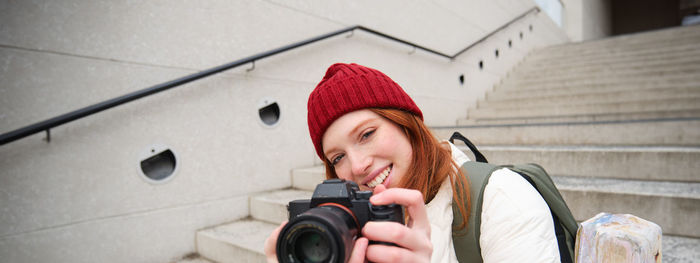 Young woman photographing with camera