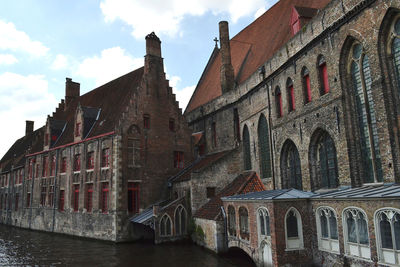 View of old building against cloudy sky