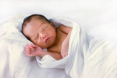 Cute baby sleeping in bed