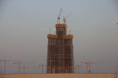 Low angle view of crane against clear sky