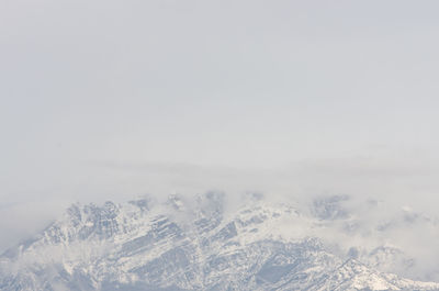Scenic view of snow covered mountains against sky