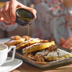 Cropped hand of person preparing food