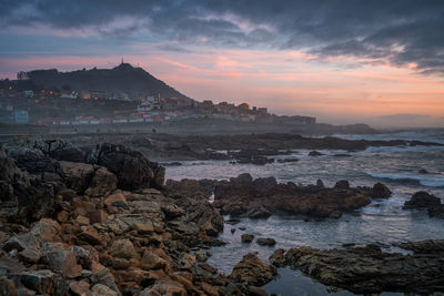 A guarda beautiful sea landscape rock beach with city on the foreground at sunset, in spain