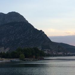 View of calm sea against mountain range