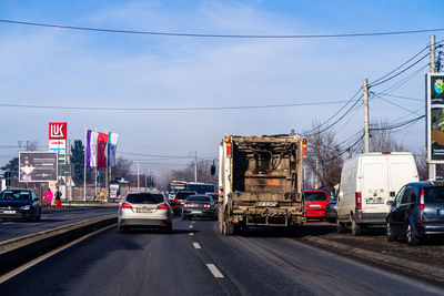 Vehicles on road against buildings in city