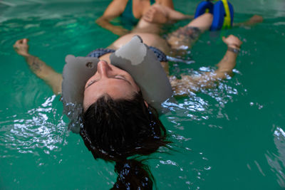 High angle view of people swimming in pool