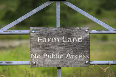 Close-up of information sign on wood
