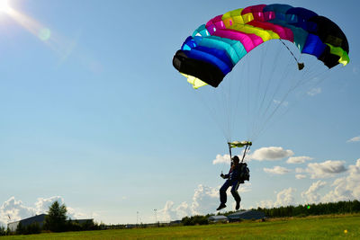 Person paragliding against sky