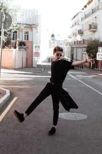 Full length portrait of man on street in city