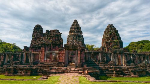 Abandoned temple against cloudy sky