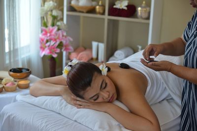 Midsection of woman lying on floor