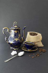 Close-up of tea cup on table against black background