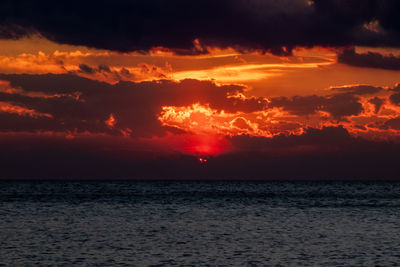 Scenic view of sea against romantic sky at sunset
